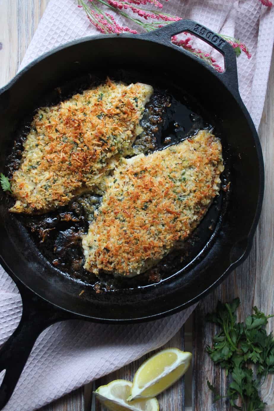 overhead shot of parmesan crusted catfish in cast iron skillet