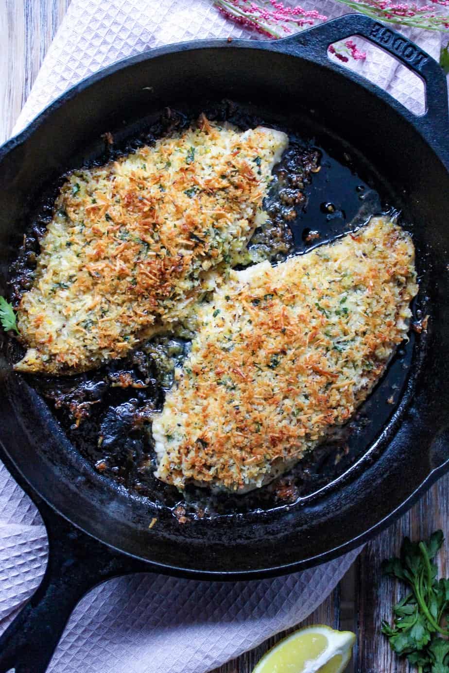 overhead shot of parmesan crusted catfish in cast iron skillet