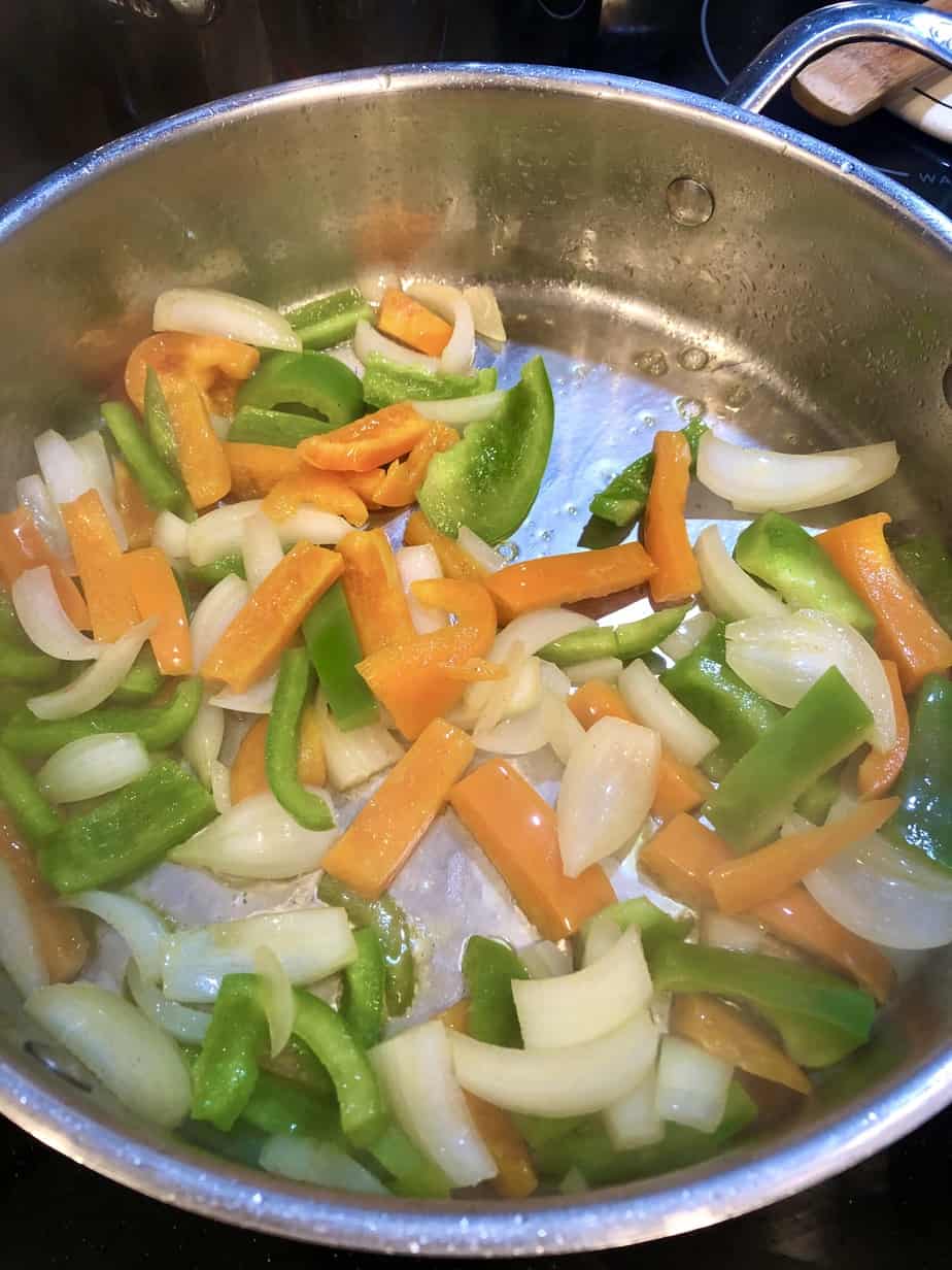 chopped veggies cooking in stainless steel skillet