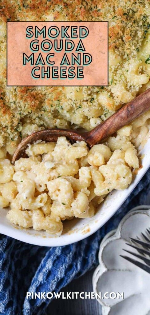 smoked gouda mac and cheese in a white baking dish with a blue linen underneath.