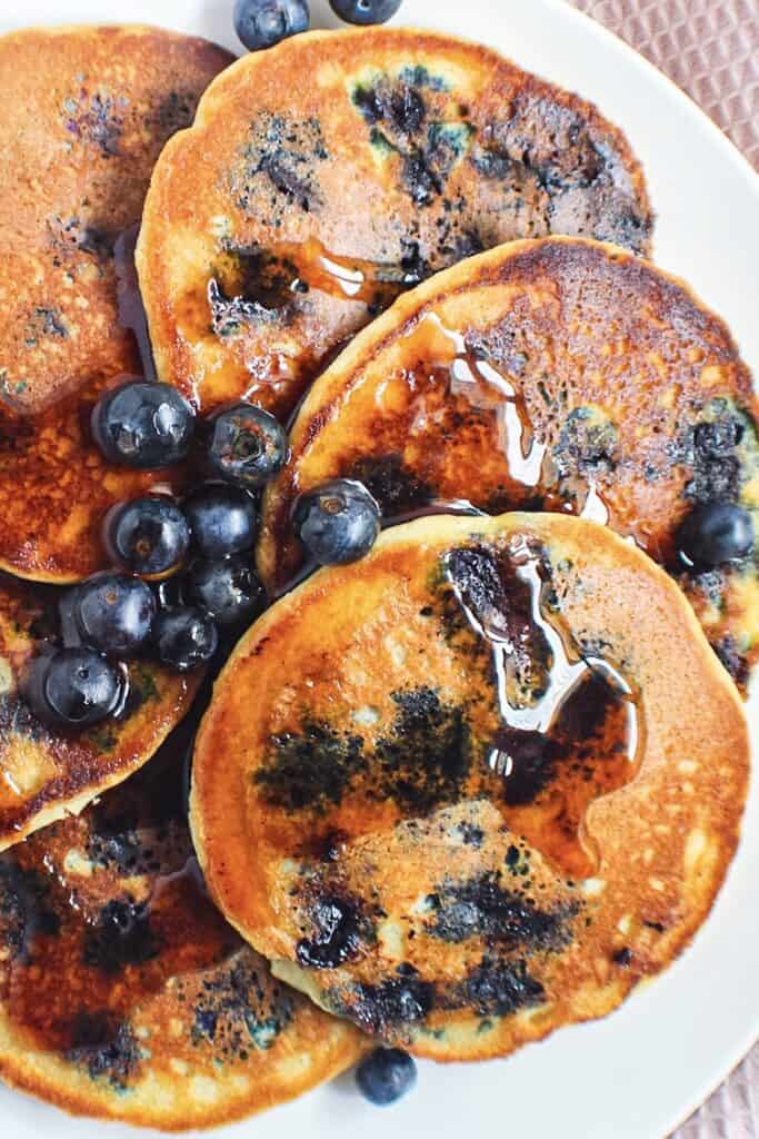 close up overhead shot of almond flour pancakes with fresh blueberries