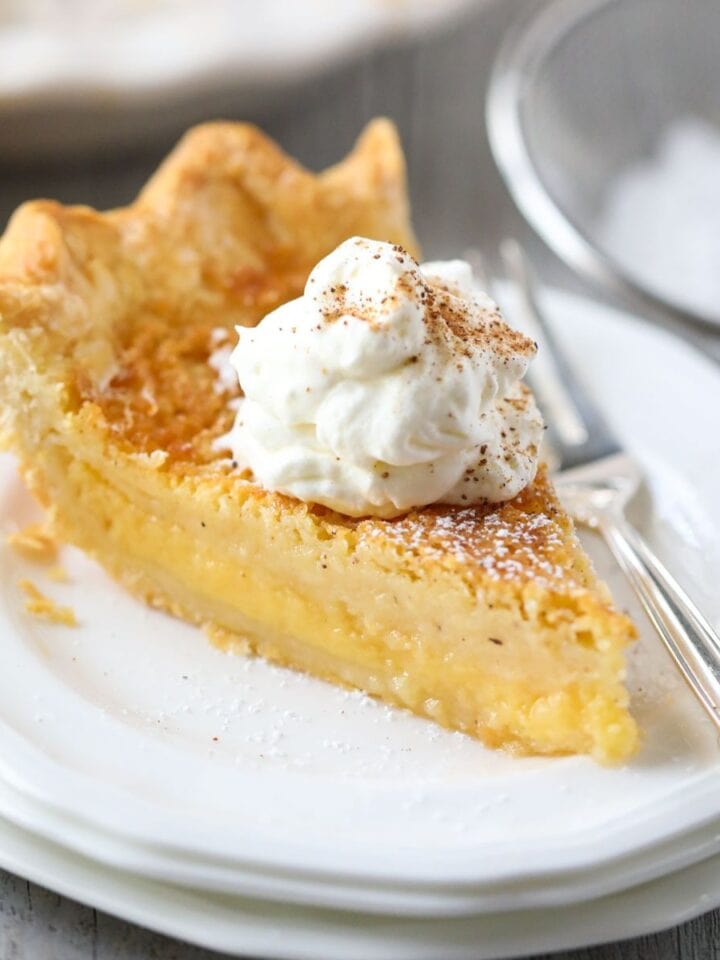 A slice of buttermilk pie on a white plate.