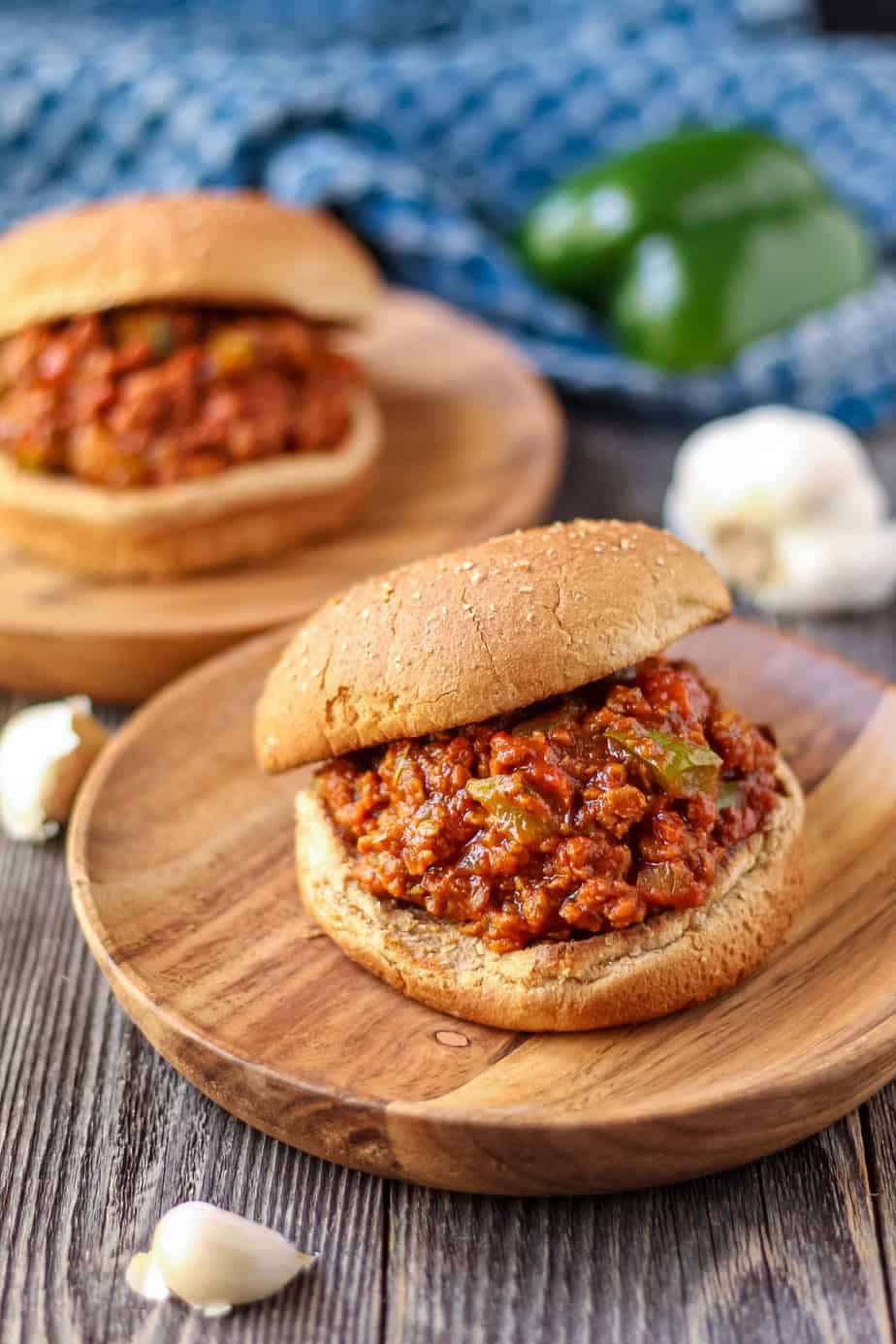 vegetarian sloppy joes on wooden plates with blue towel in background.