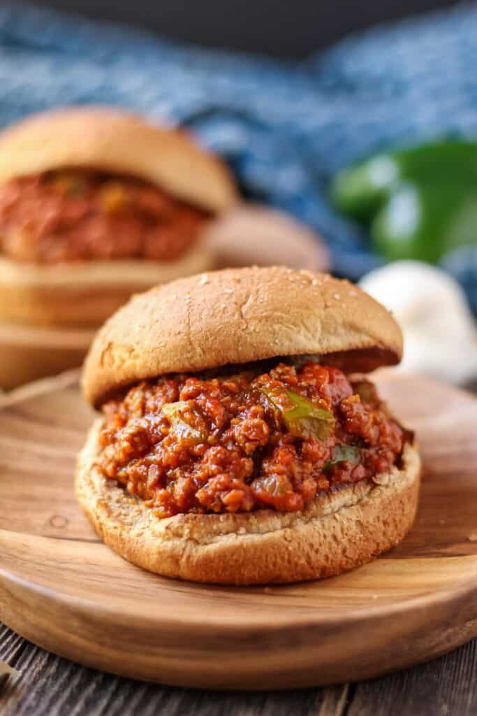 vegetarian sloppy joes on wooden plates with blue towel in background.
