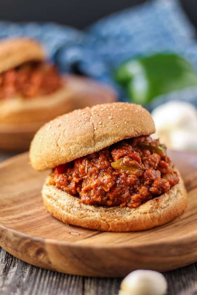 vegetarian sloppy joes on wooden plates with blue towel in background.
