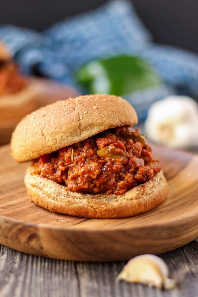 vegetarian sloppy joes on wooden plates with blue towel in background.