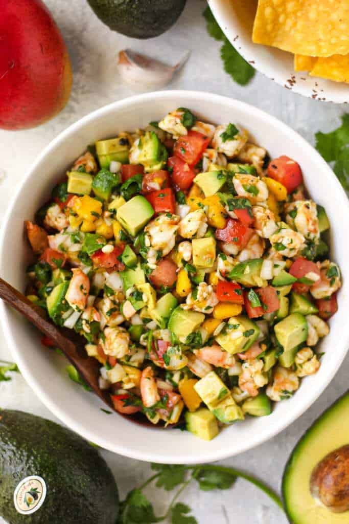 overhead shot of Avocado, shrimp and mango ceviche in white bowl