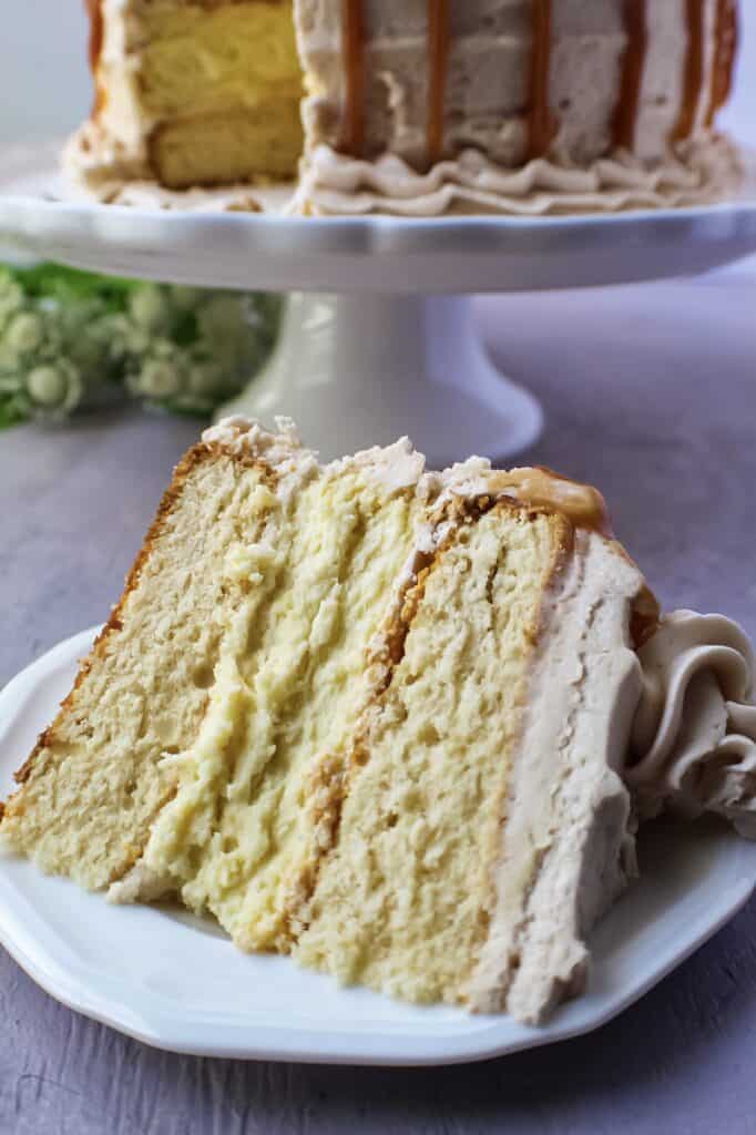 close up of slice of caramel cheesecake layer cake