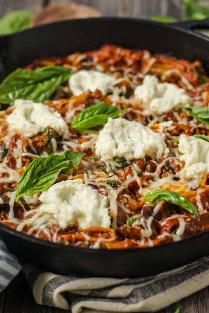 side angle shot of skillet lasagna in cast iron skillet.
