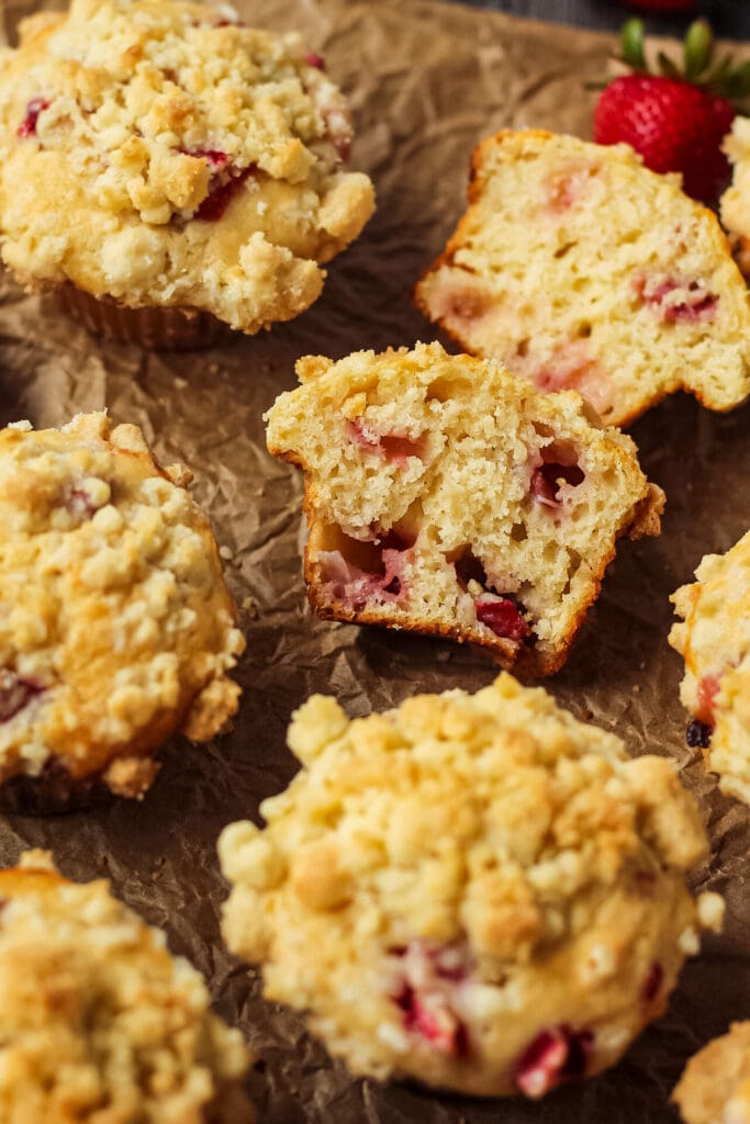 overhead shot of strawberry crumble muffins on parchment paper