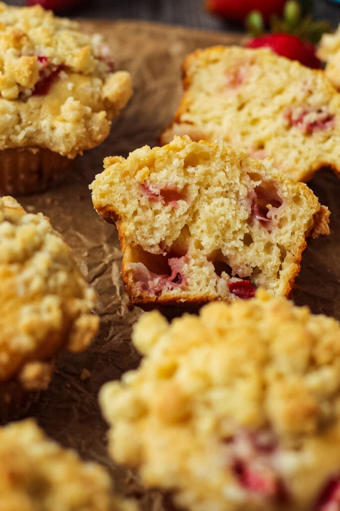 overhead shot of strawberry crumble muffins on parchment paper