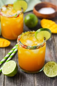 side angle shot of virgin mango margaritas on wooden surface