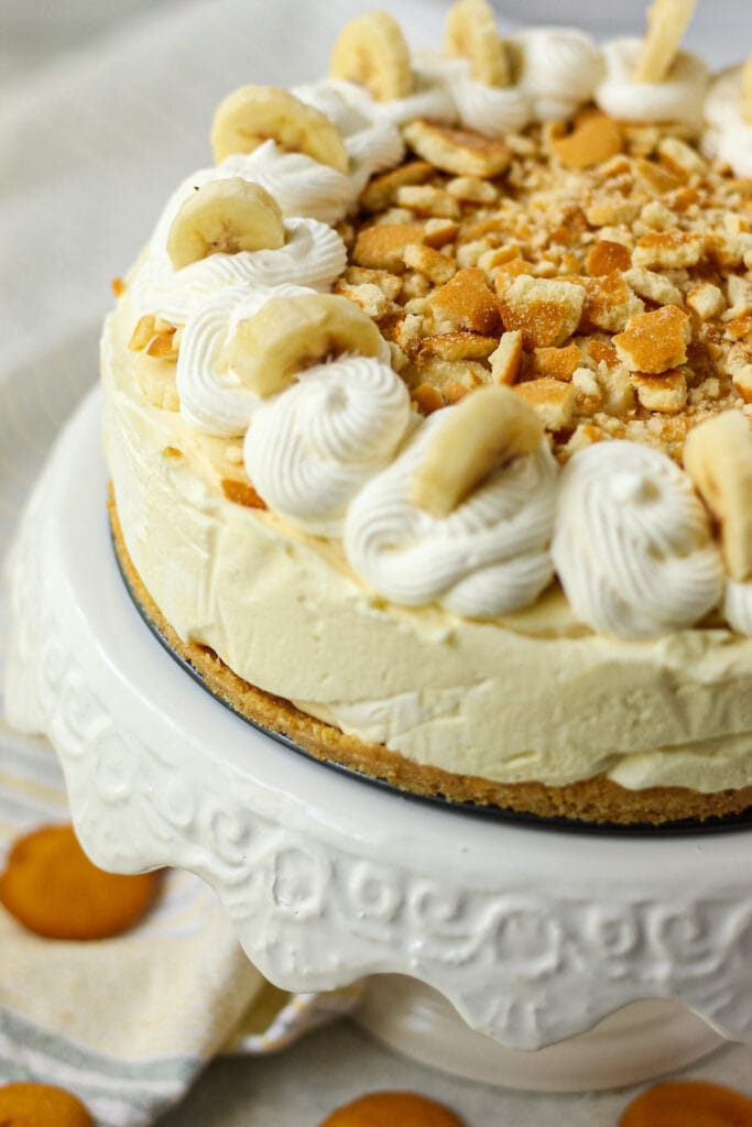 close up shot of banana pudding icebox pie on white cake stand
