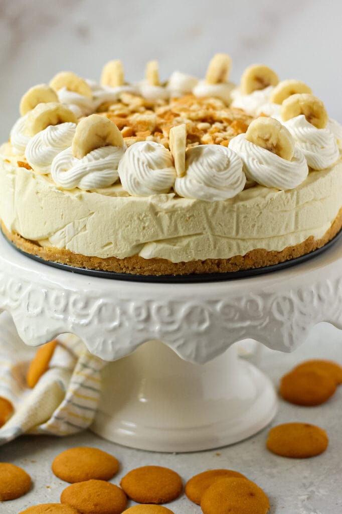 side angle shot of banana pudding icebox pie on white cake stand