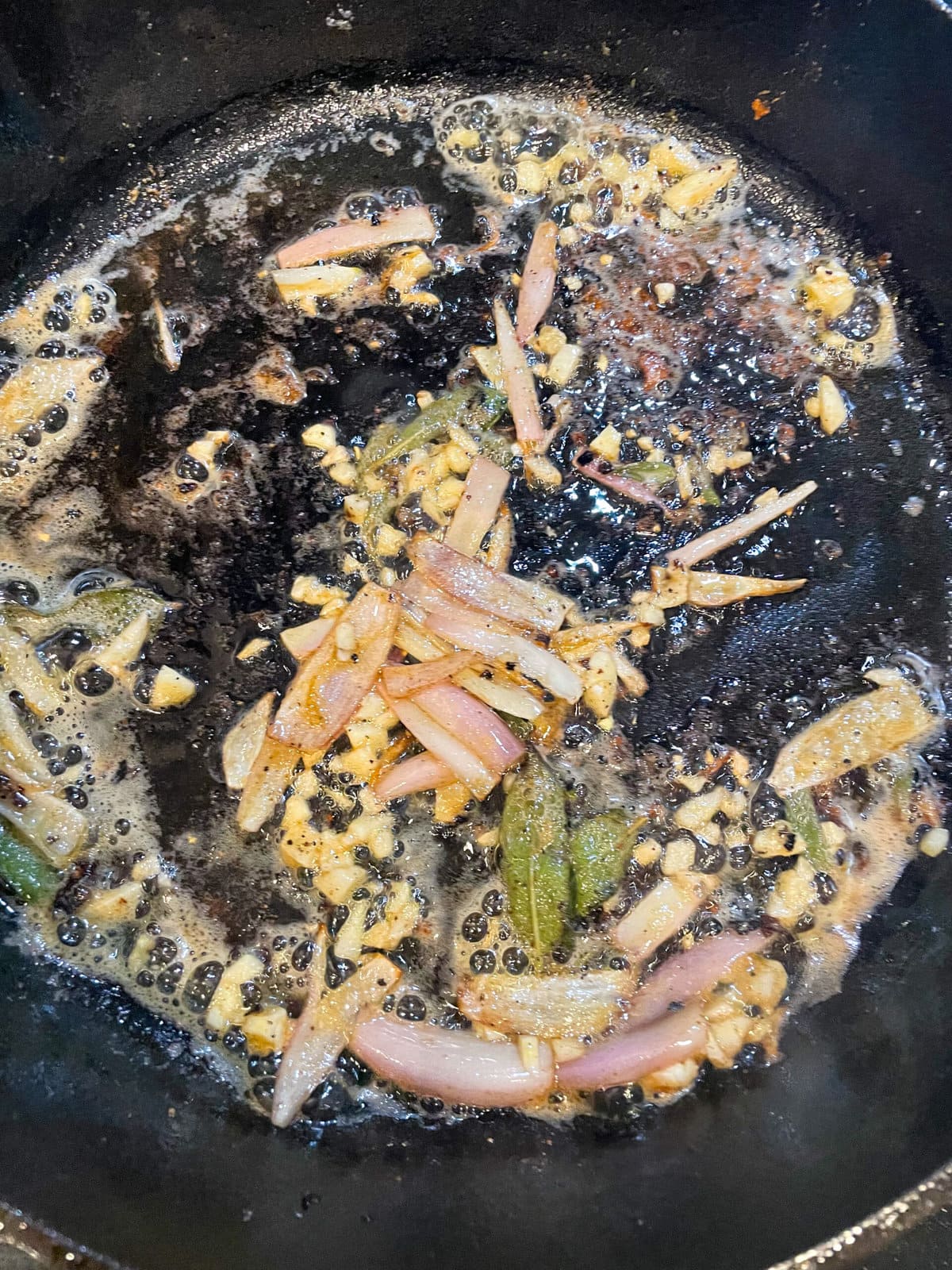 shallot, garlic and sage cooking in cast iron skillet