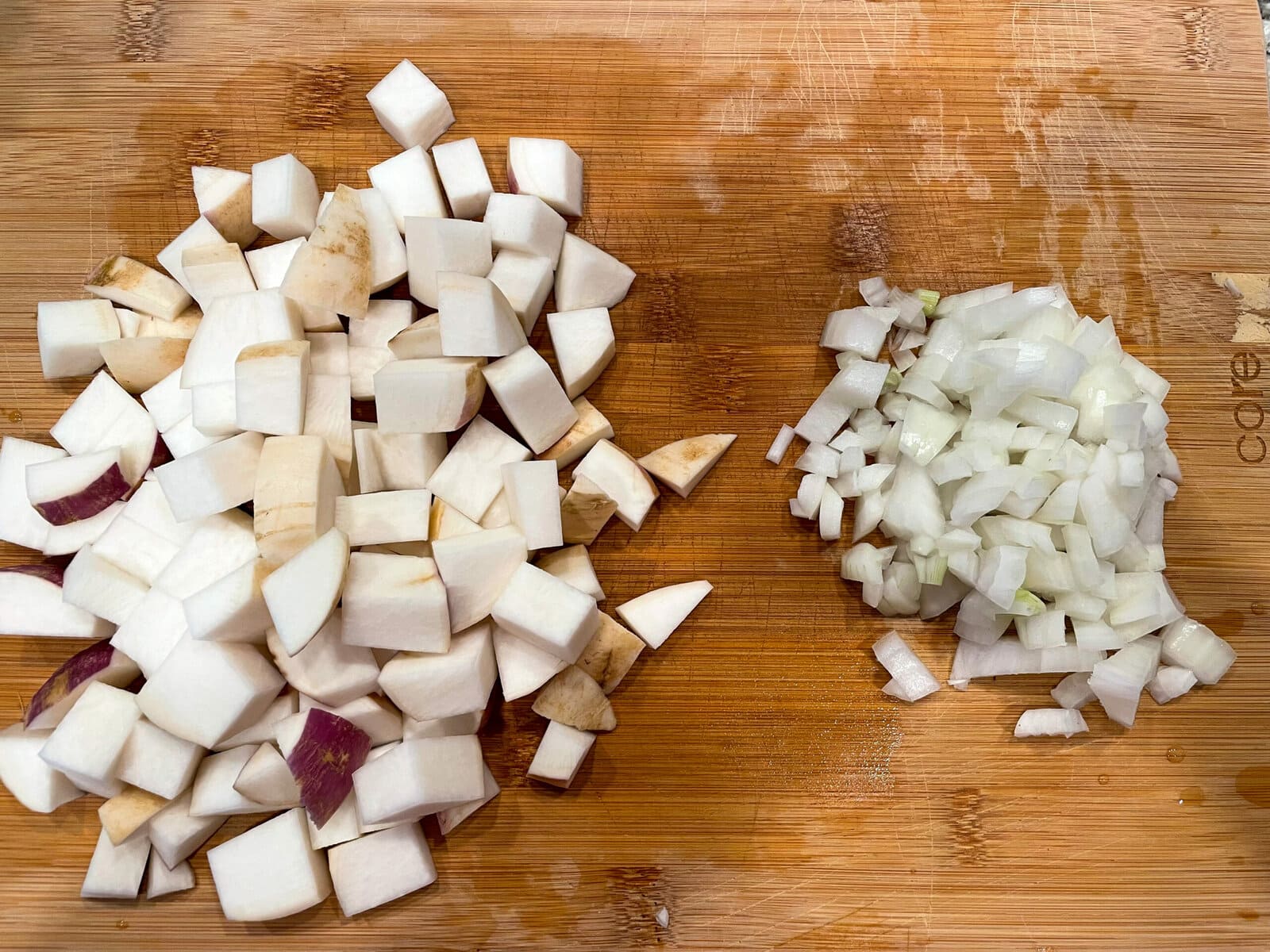 chopped turnip root and onion on cutting board.