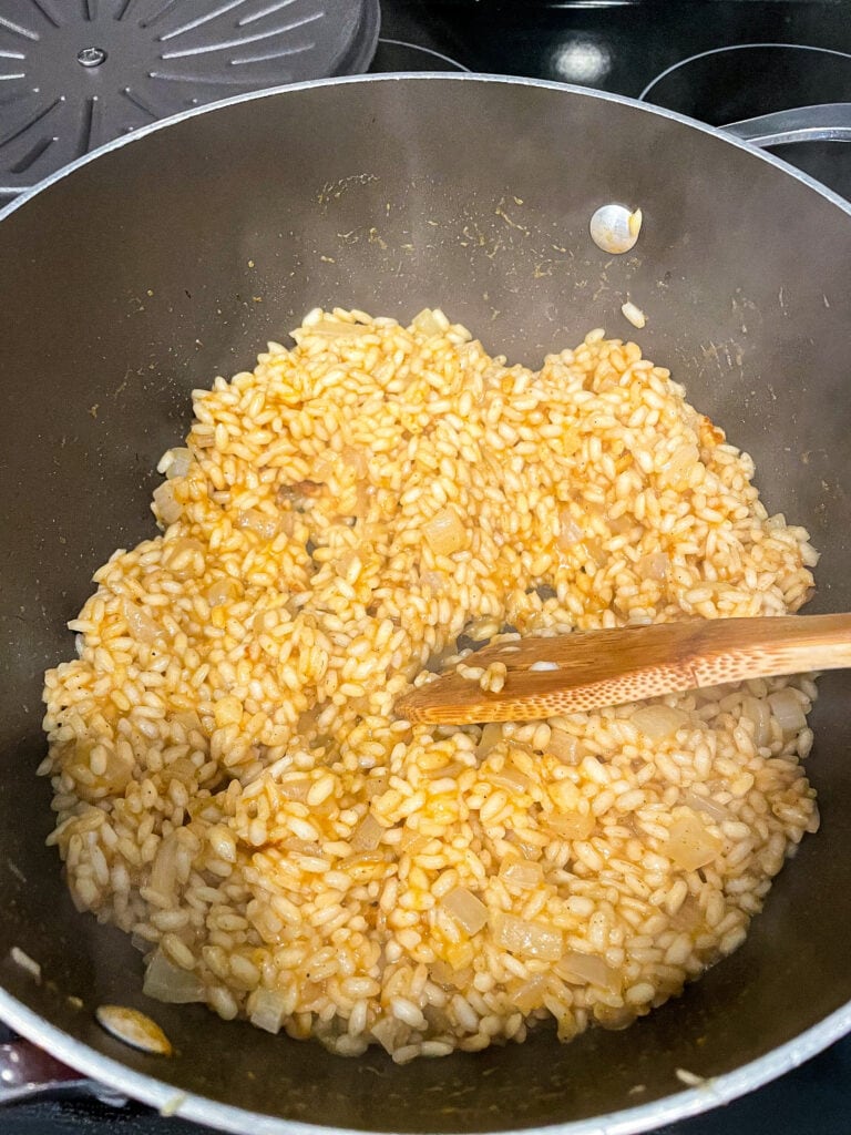 overhead shot of risotto after half of broth has been added and cooked in risotto.