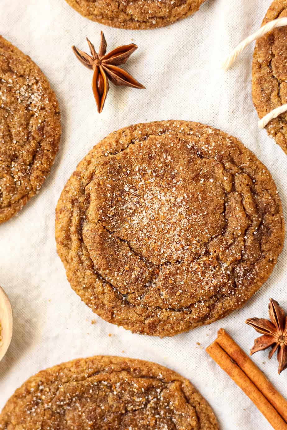 close up shot of chewy chai molasses cookies on a white linen.