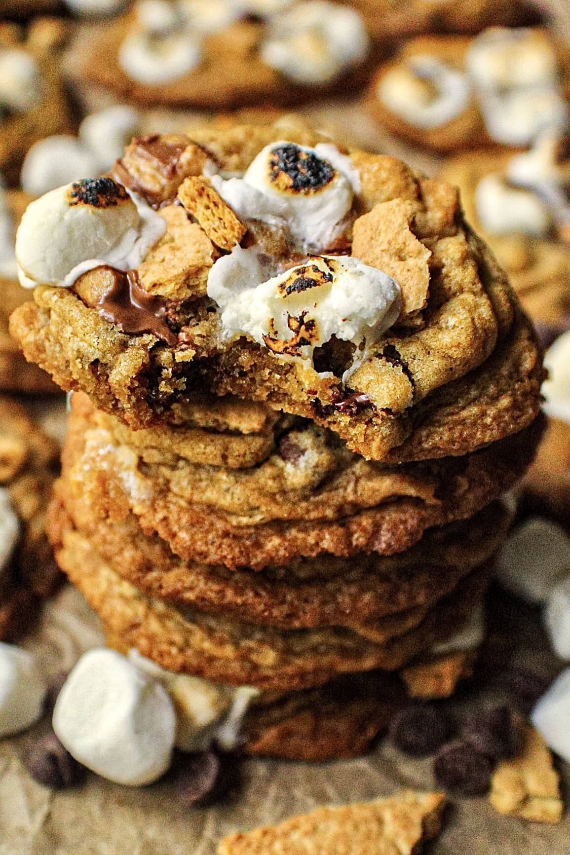 overhead shot of a stack of peanut butter cup s',ores cookies on parchment paper.