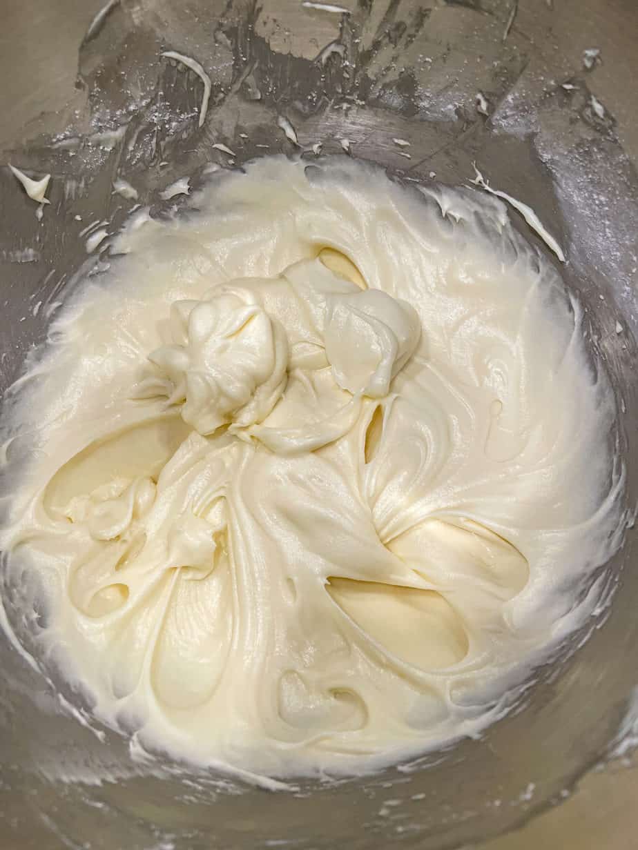 overhead shot of Cream cheese frosting in a mixing bowl