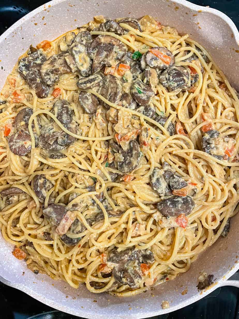 overhead shot of Mushroom sauce combined with pasta in a skillet.