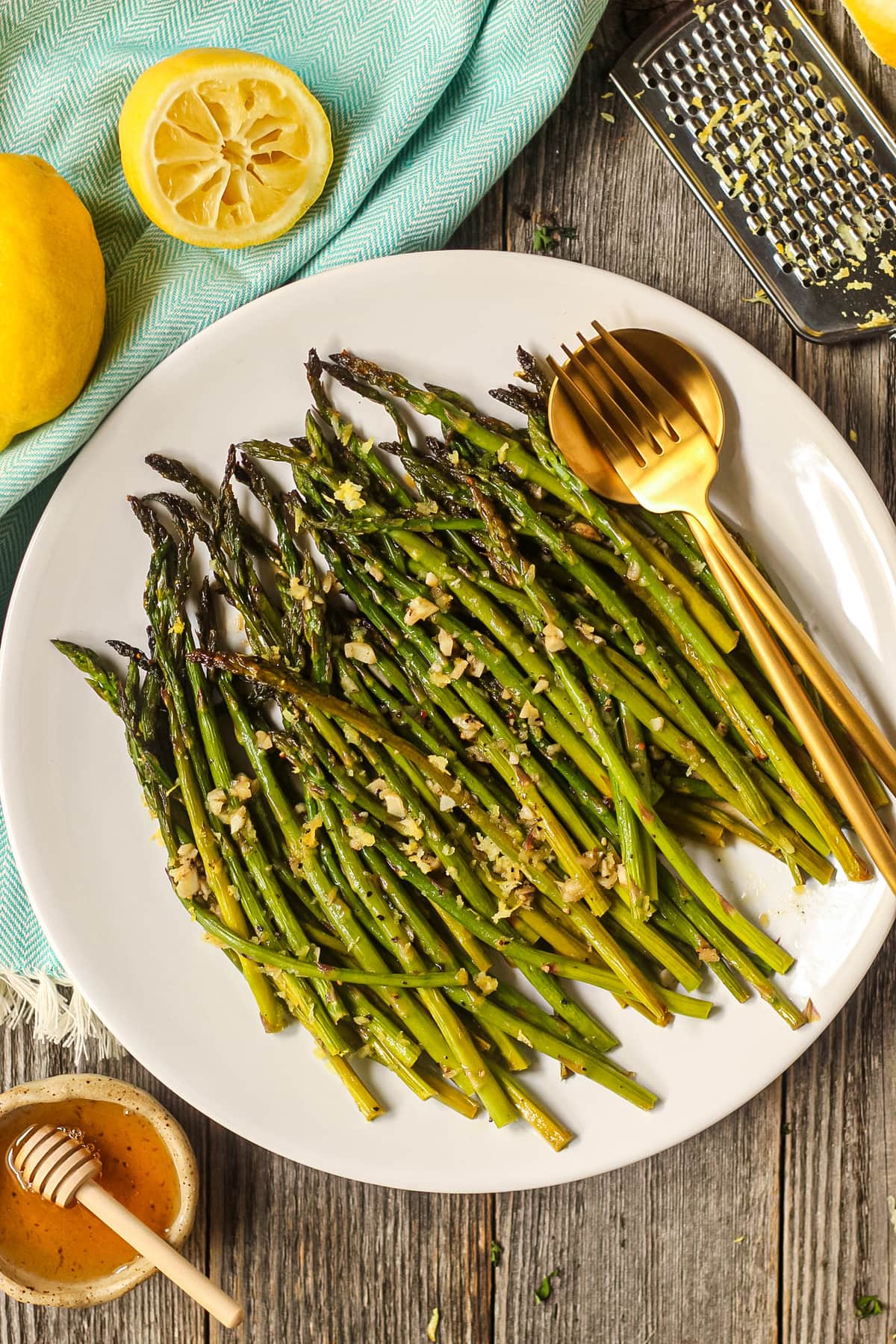 honey lemon butter roasted asparagus on a white plate