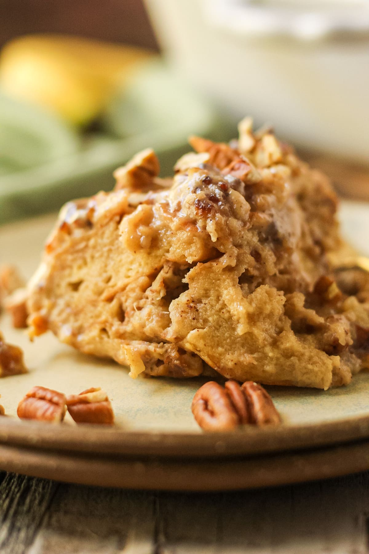 hummingbird bread pudding with praline sauce on a gray plate.