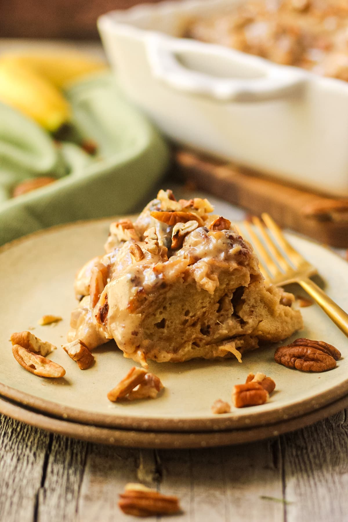 hummingbird bread pudding with praline sauce on a gray plate.