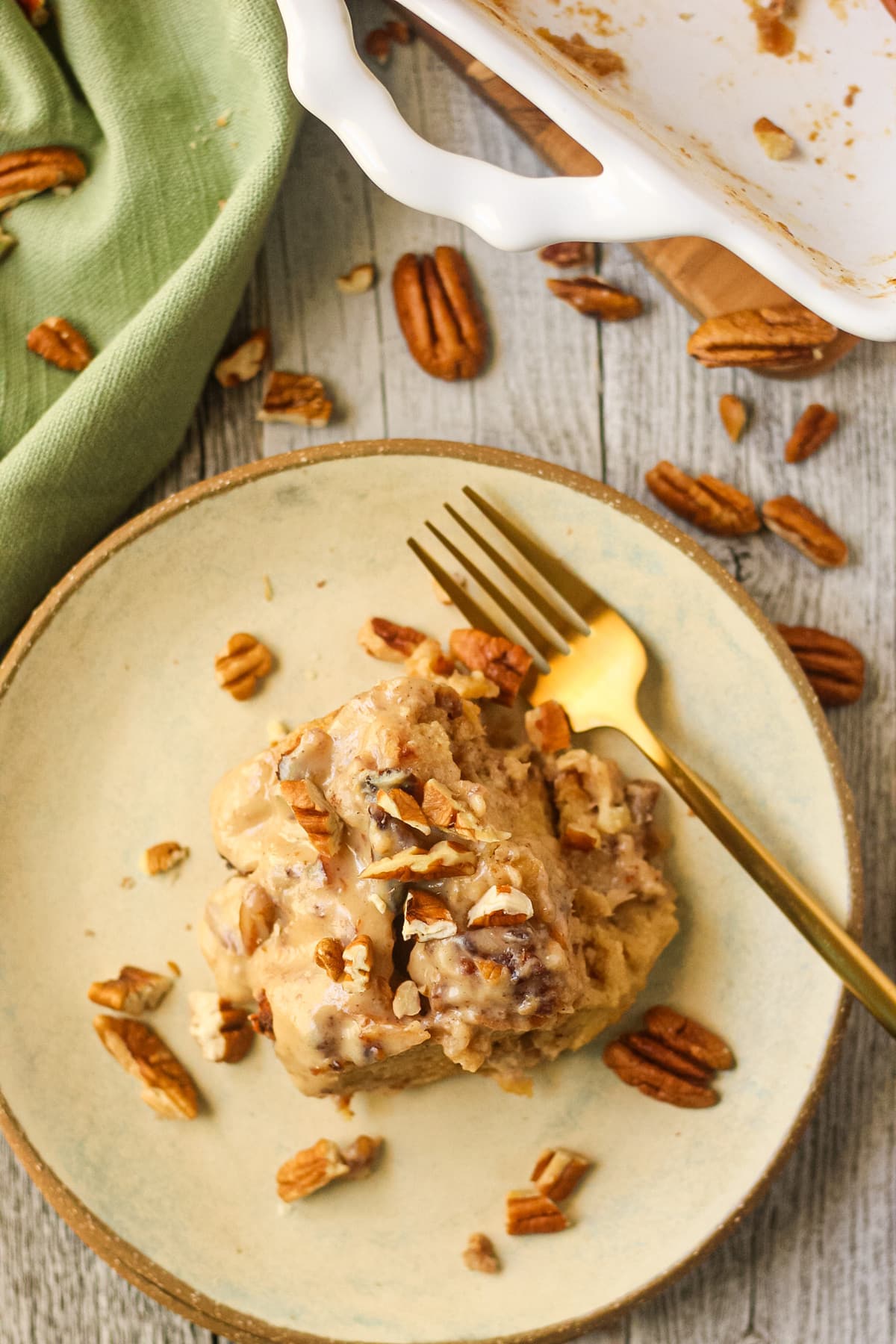 hummingbird bread pudding with praline sauce on a gray plate.