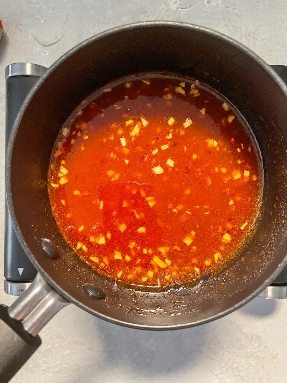 overhead shot of hot honey butter in a small saucepan