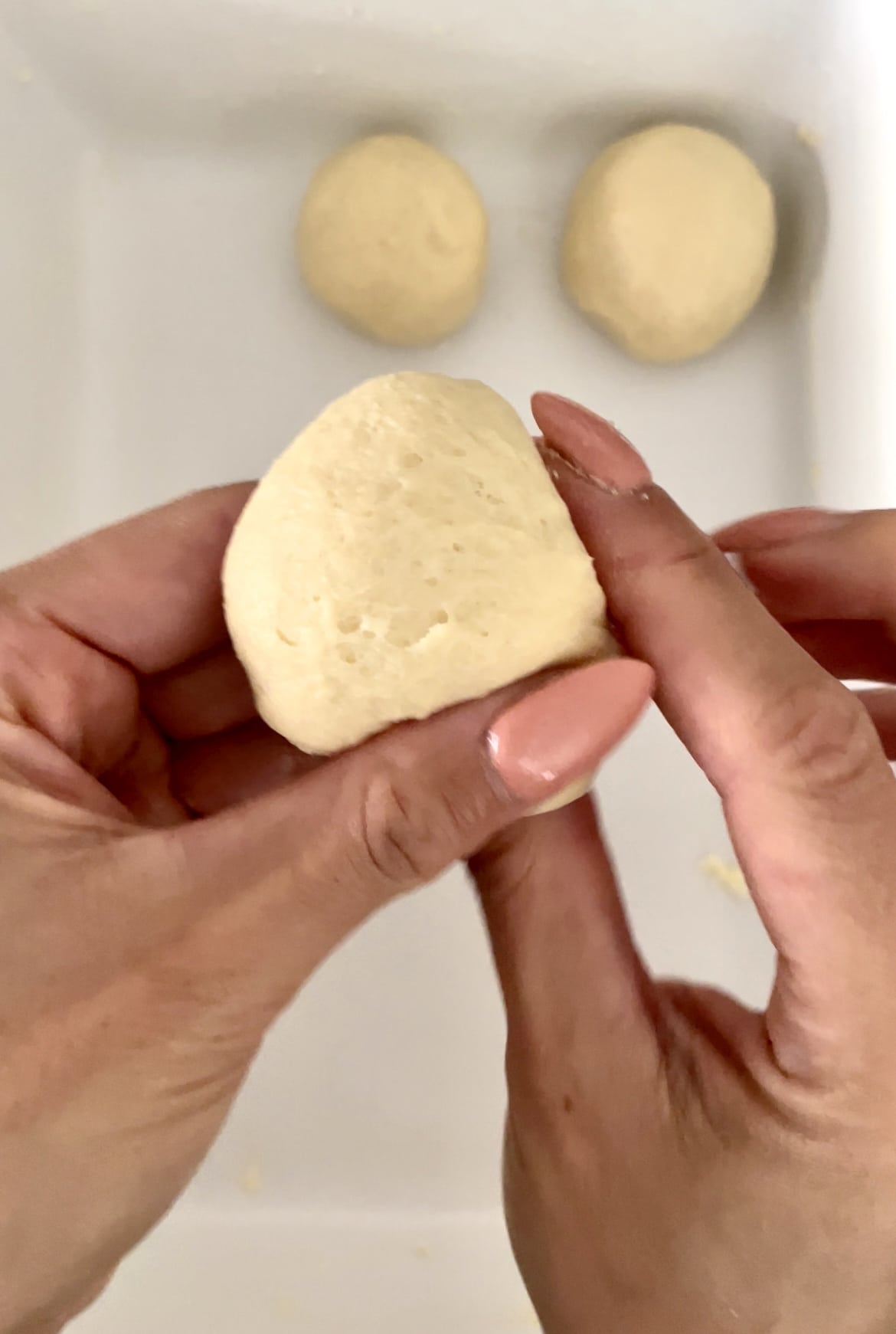 forming dough into balls for yeast rolls