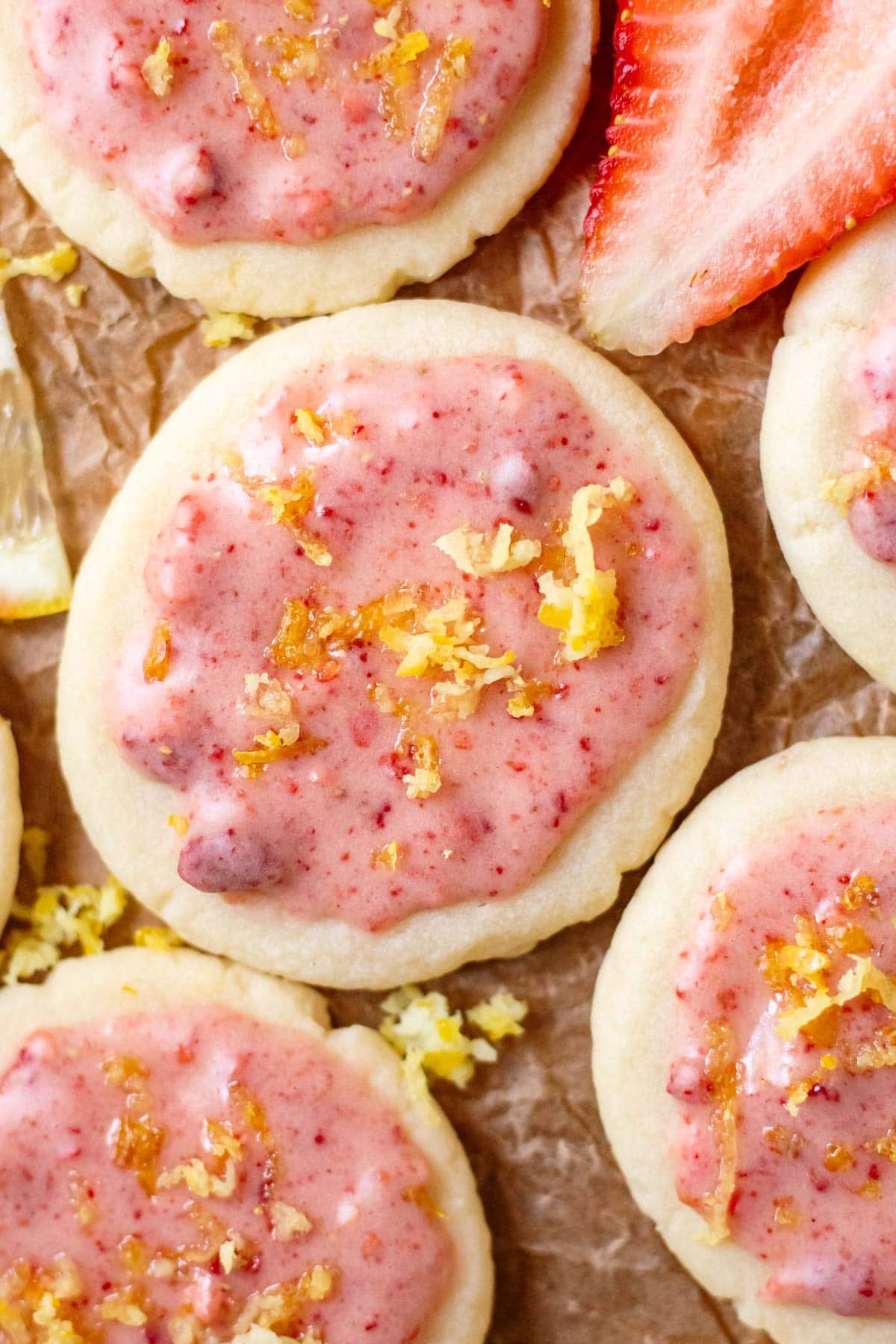 lemon shortbread cookies with strawberry glaze on parchment paper