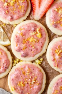 lemon shortbread cookies with strawberry glaze on parchment paper