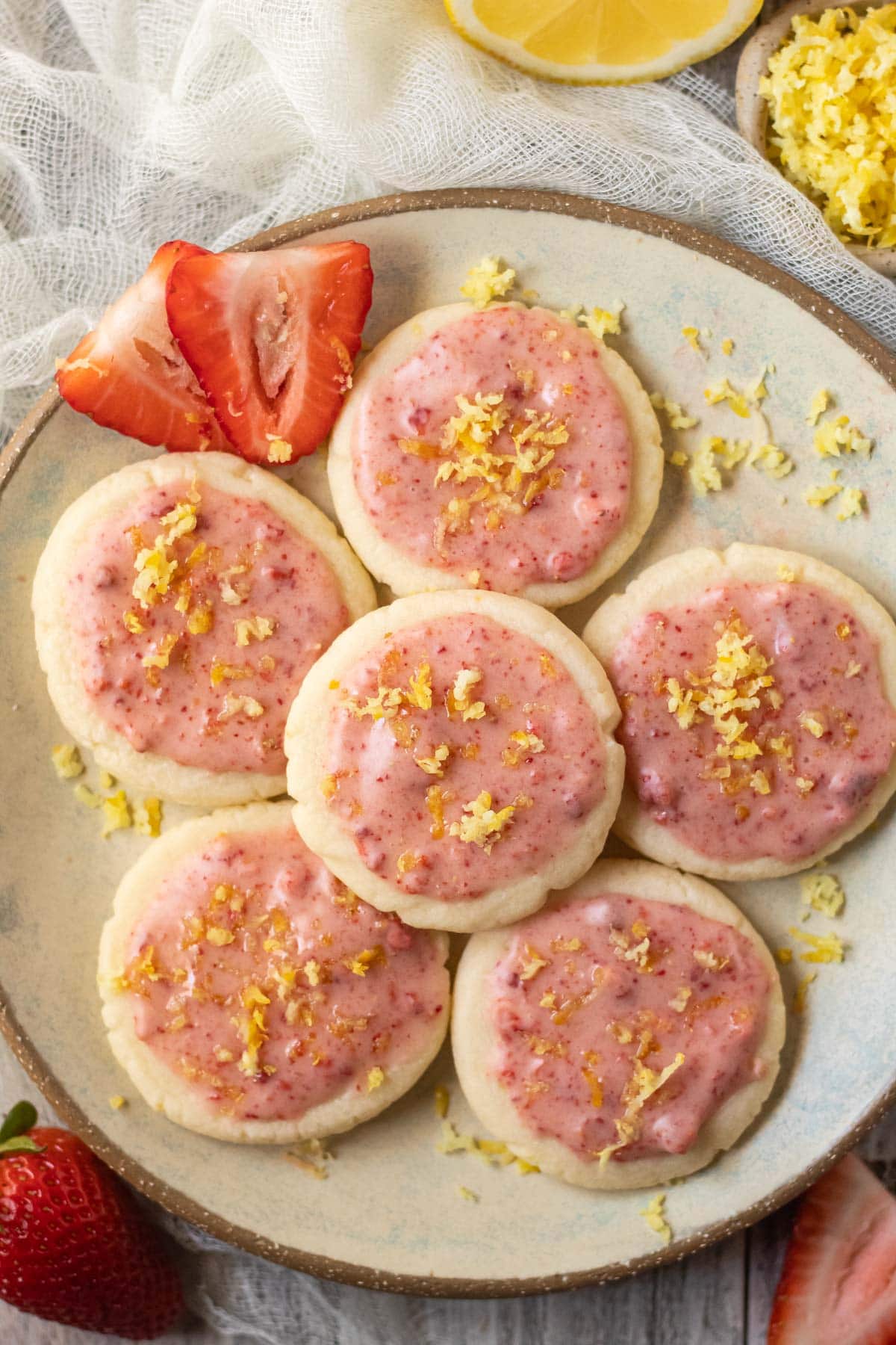 lemon shortbread cookies with strawberry glaze on a gray plate