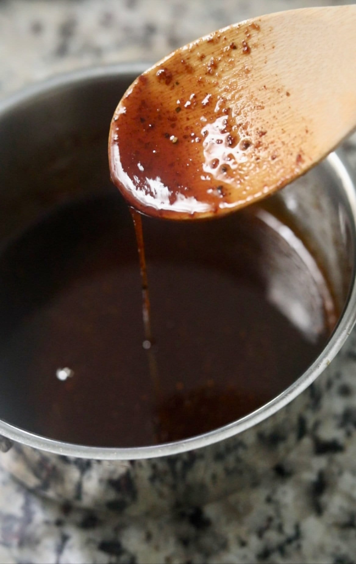 brown sugar glaze on a wooden spoon.