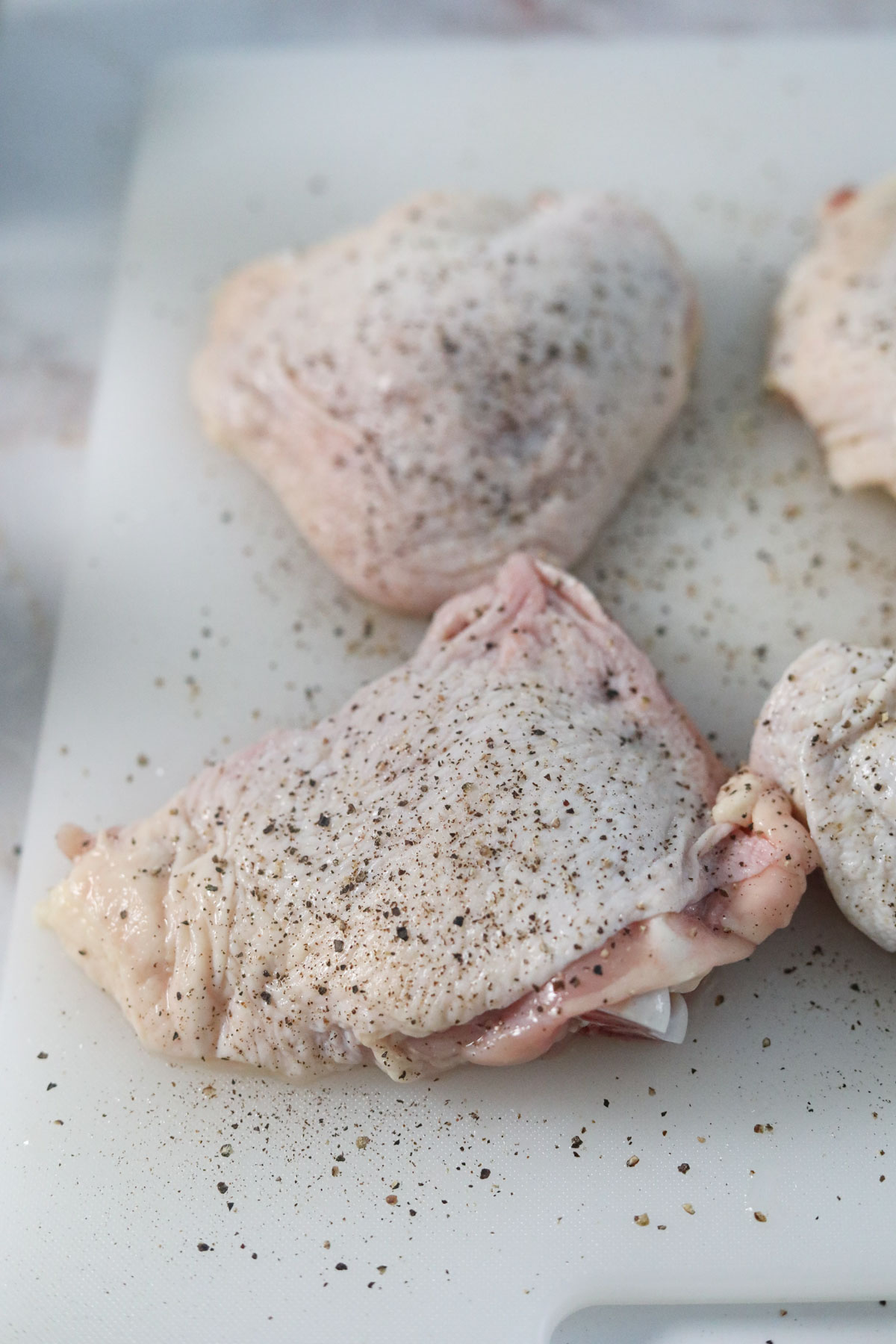 raw chicken seasoned with salt and pepper.