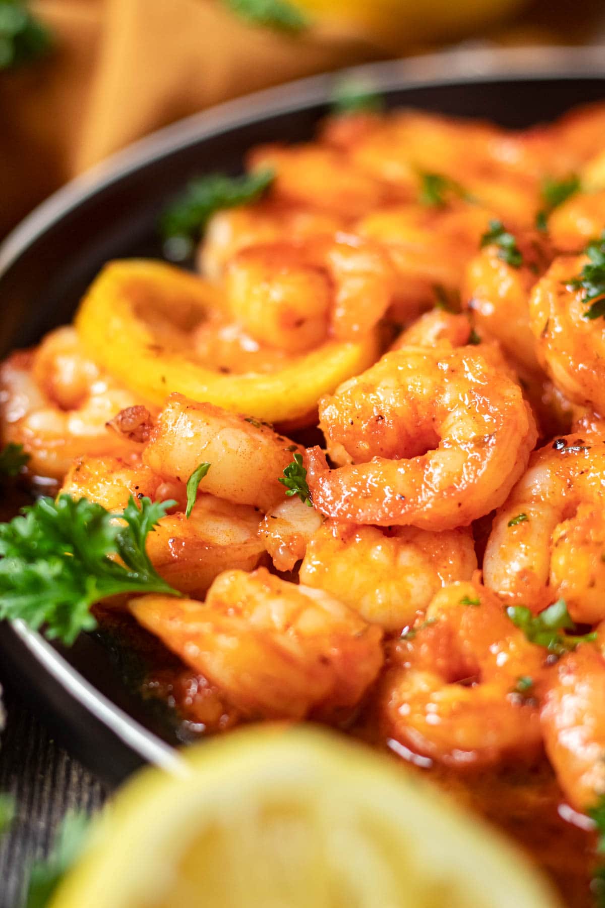 close up of cajun honey butter shrimp on black plate