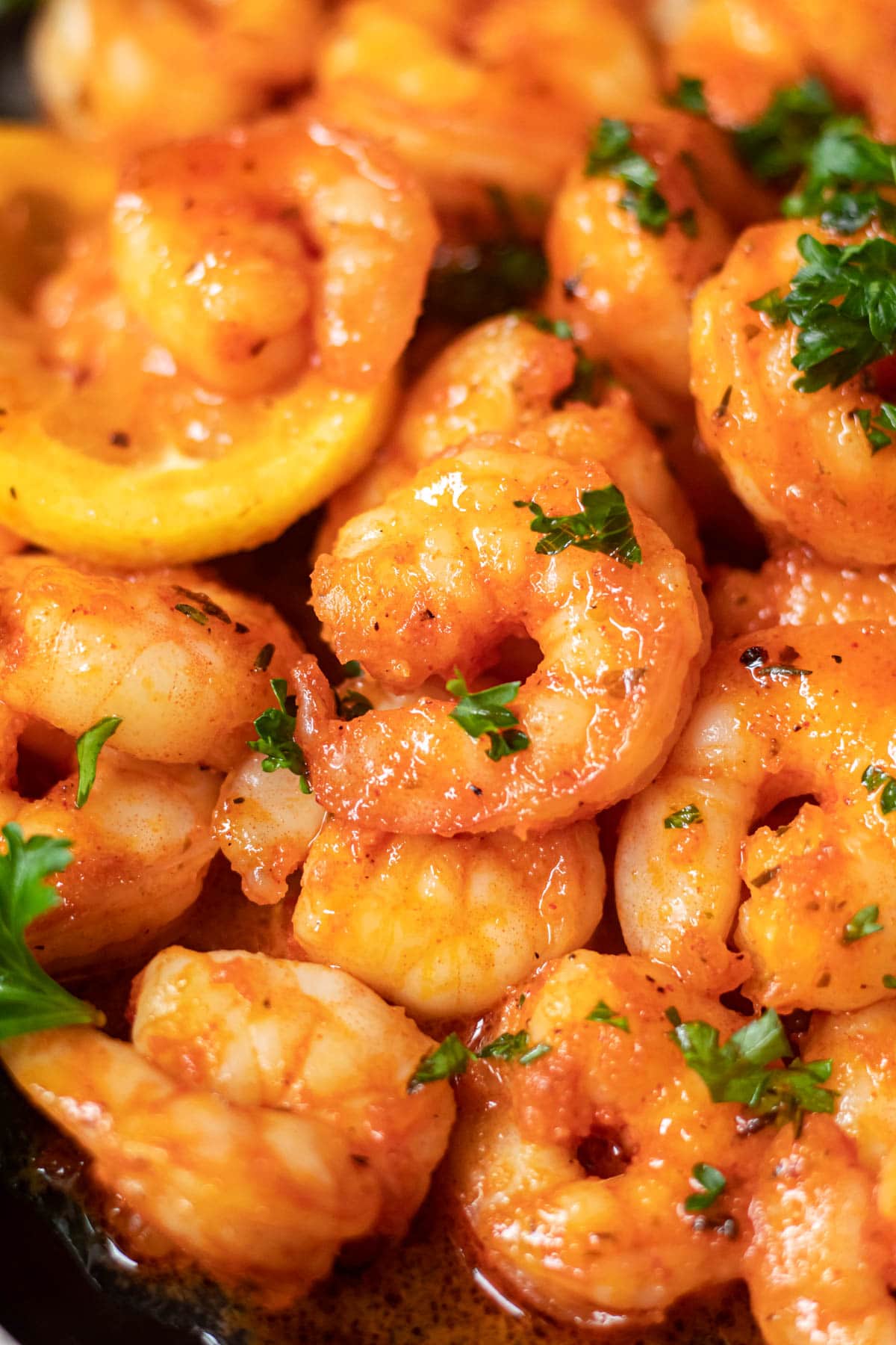 close up of cajun honey butter shrimp on black plate