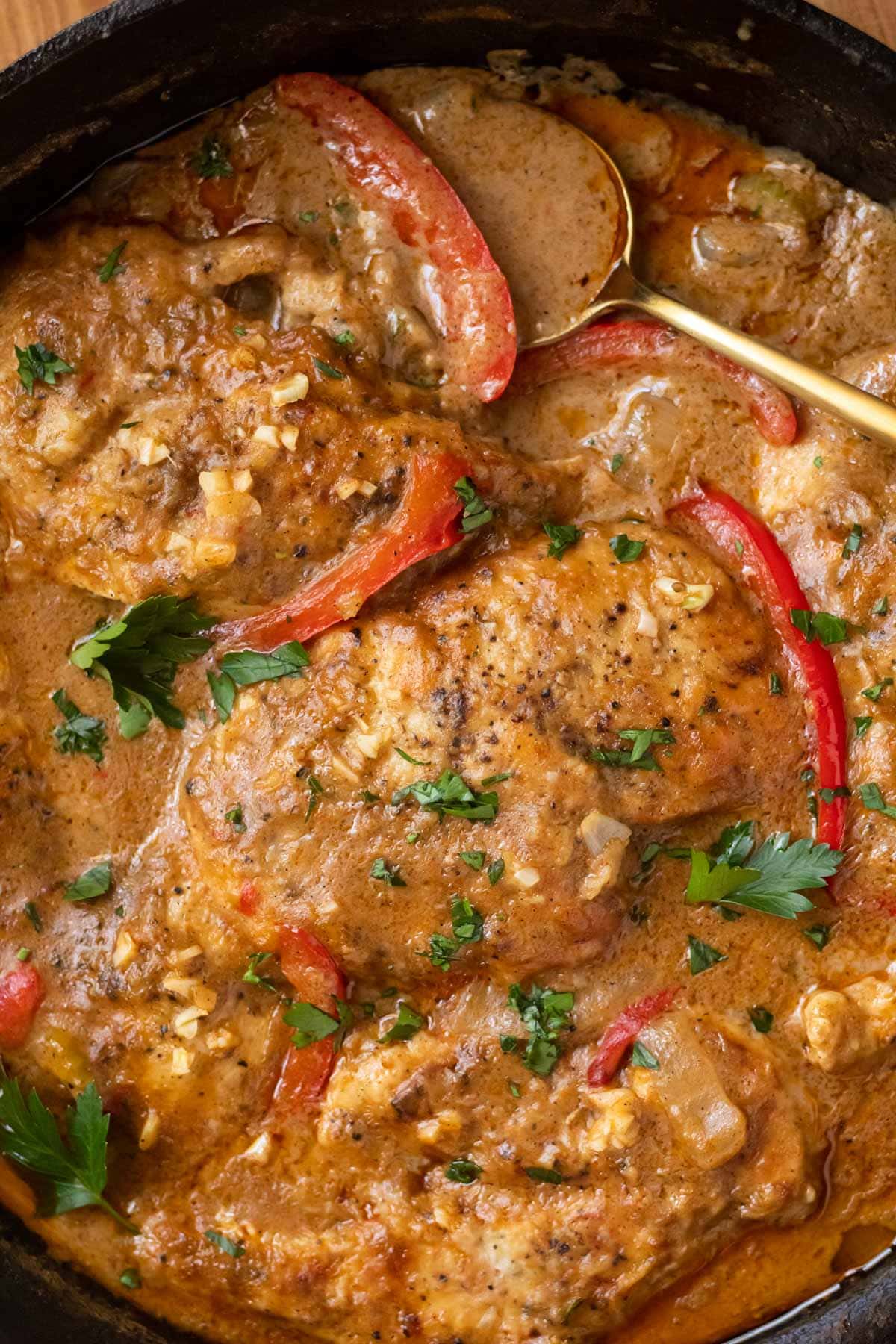 detail shot of cajun smothered chicken in skillet.