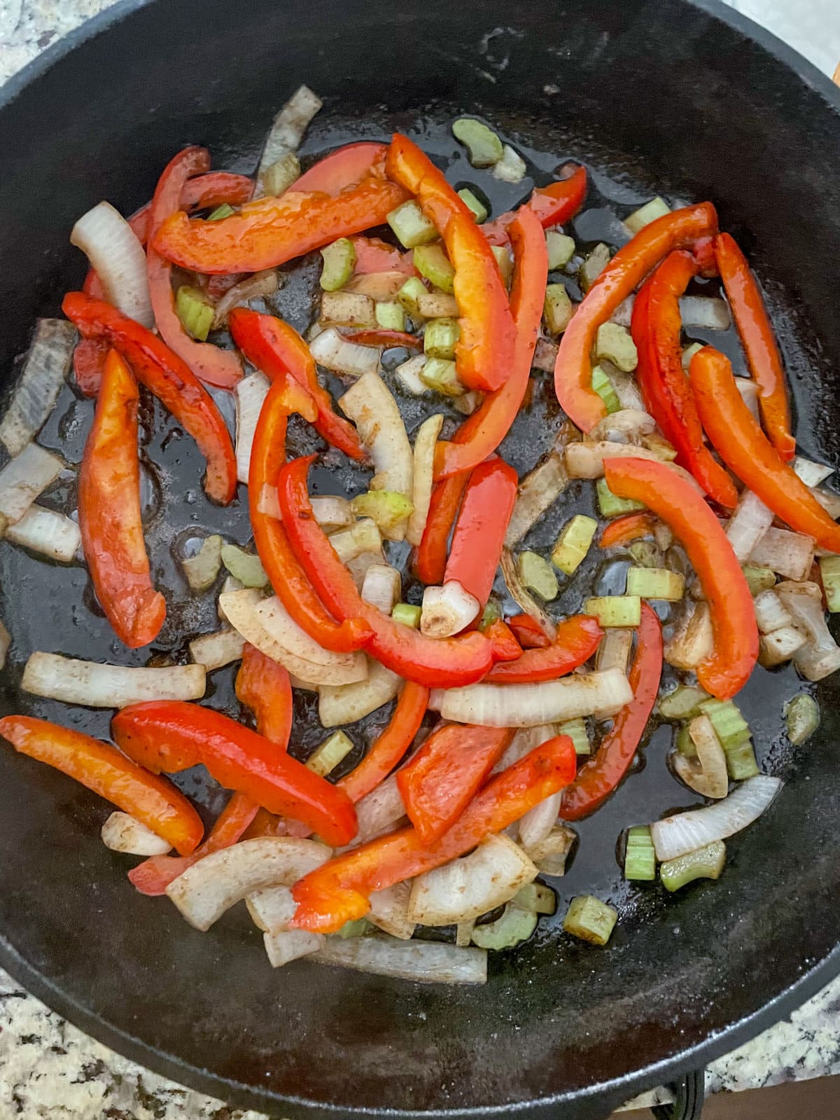 veggies cooking in skillet.