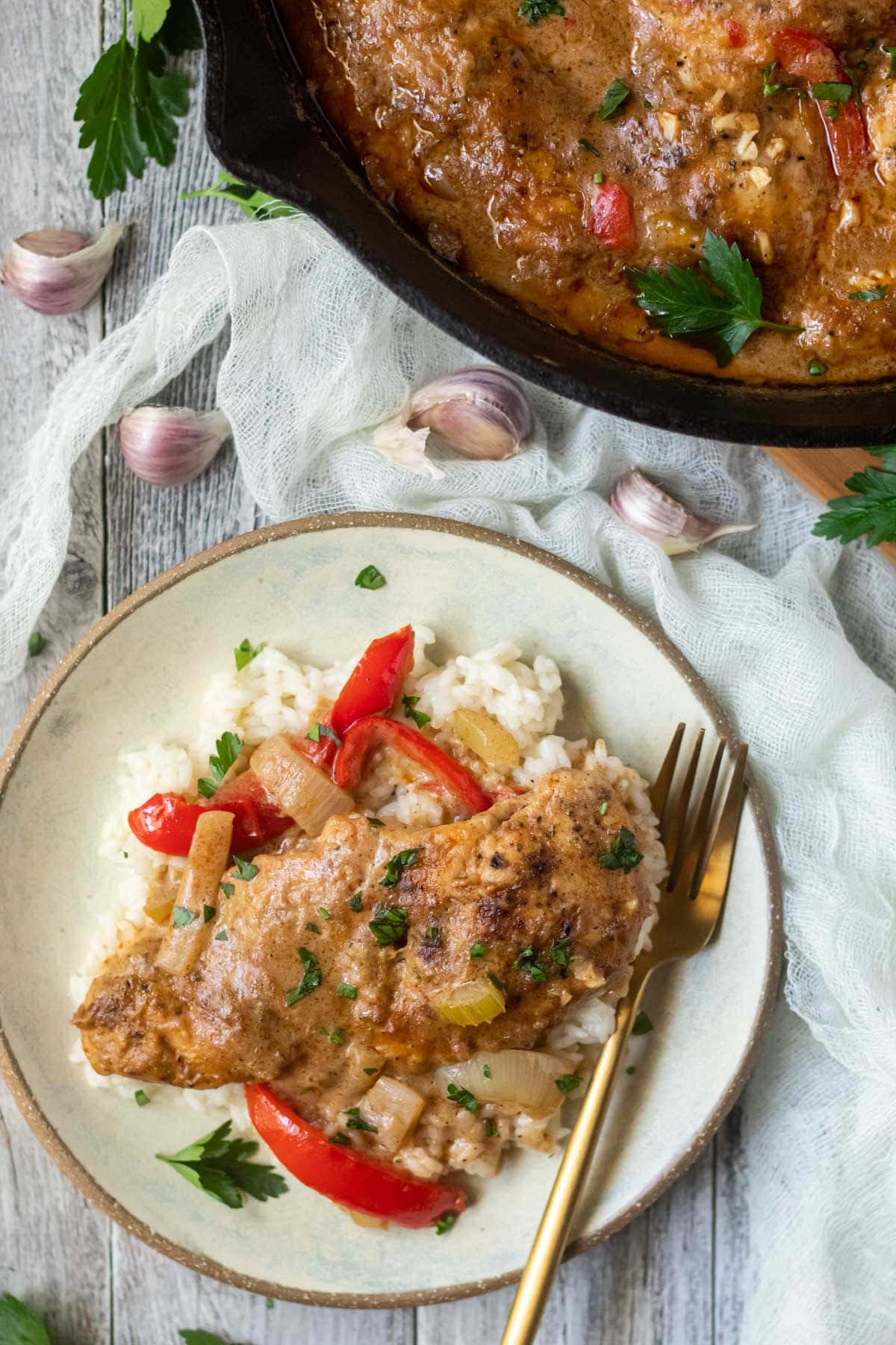 cajun smothered chicken on a gray plate.