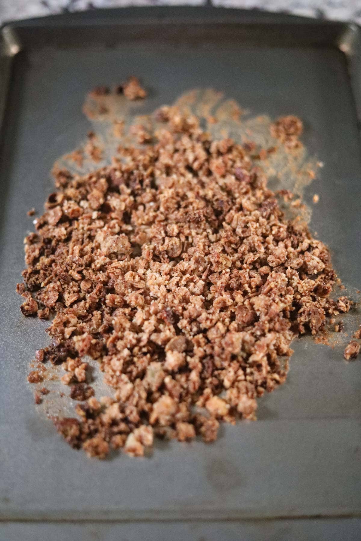 granola crumble topping on a baking sheet.