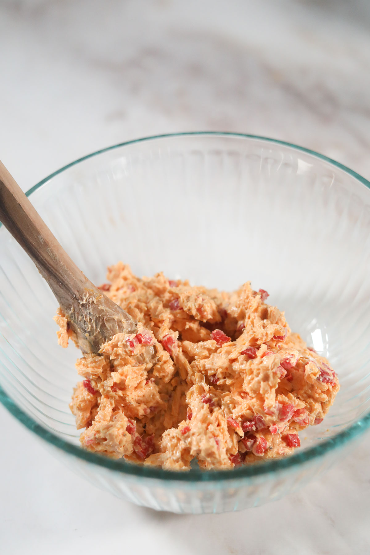 pimento cheese in a glass mixing bowl.