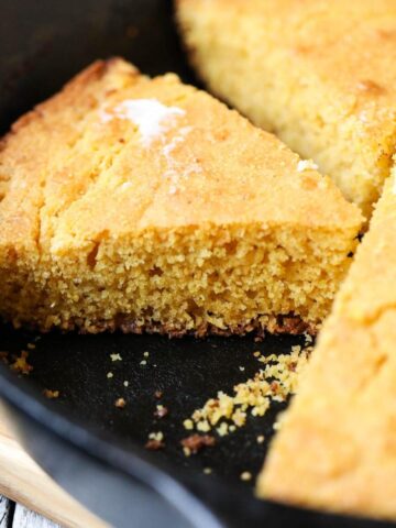 close up of sliced southern buttermilk cornbread in a cast iron skillet.
