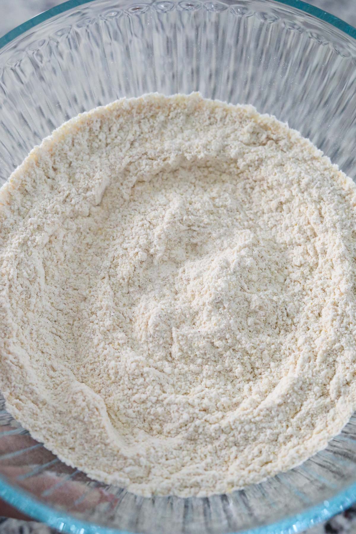 cornmeal breading for fried green tomatoes in a glass mixing bowl.