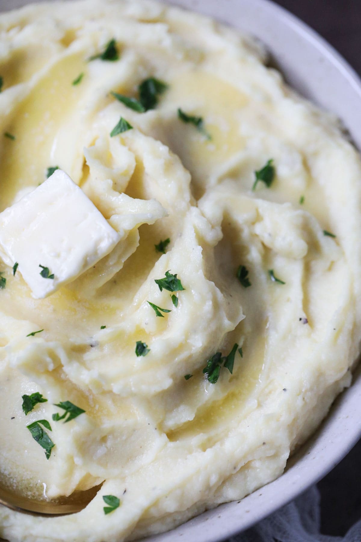 creamy garlic mashed potatoes in a white bowl.