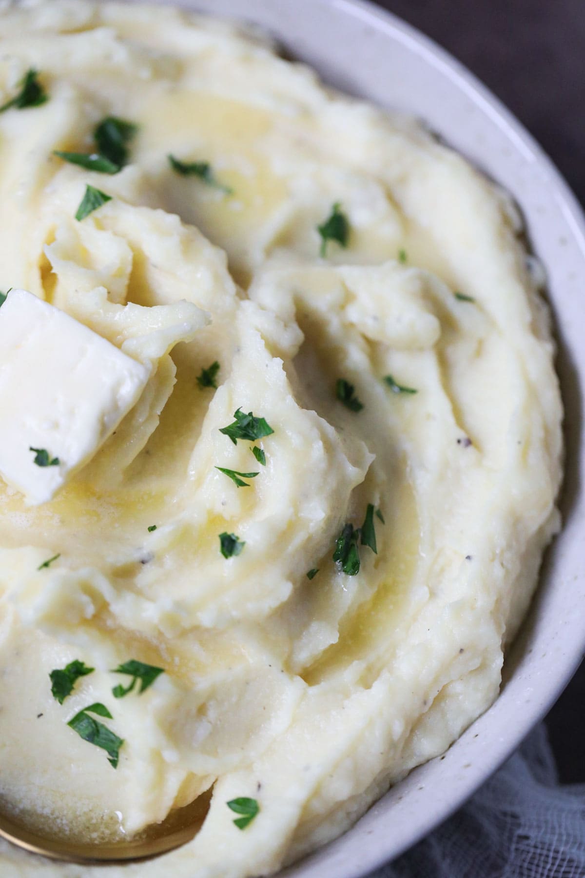 creamy garlic mashed potatoes in a white bowl.