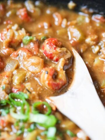 crawfish etouffee on a wooden spoon to show detail.