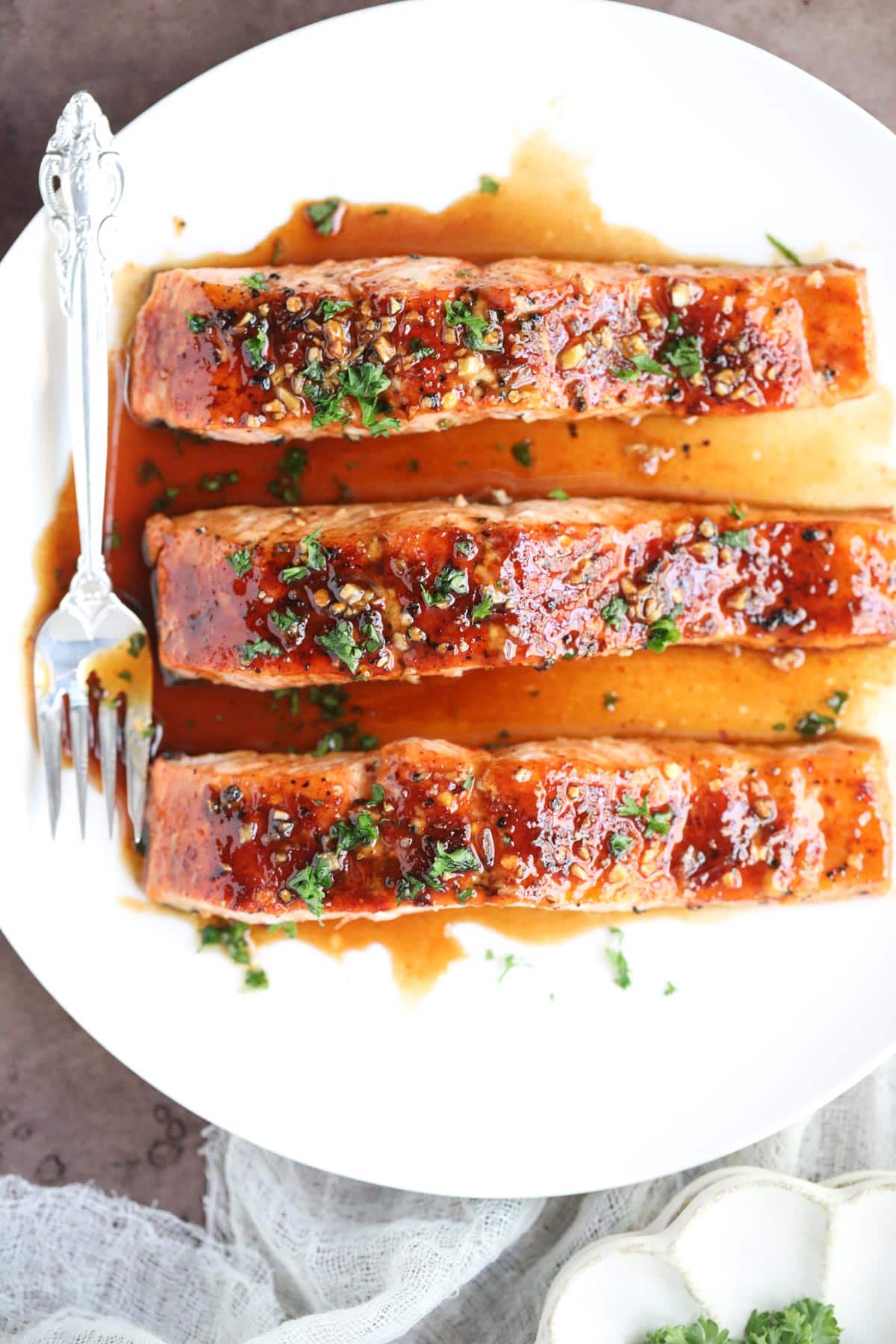 maple glazed salmon on a white plate.