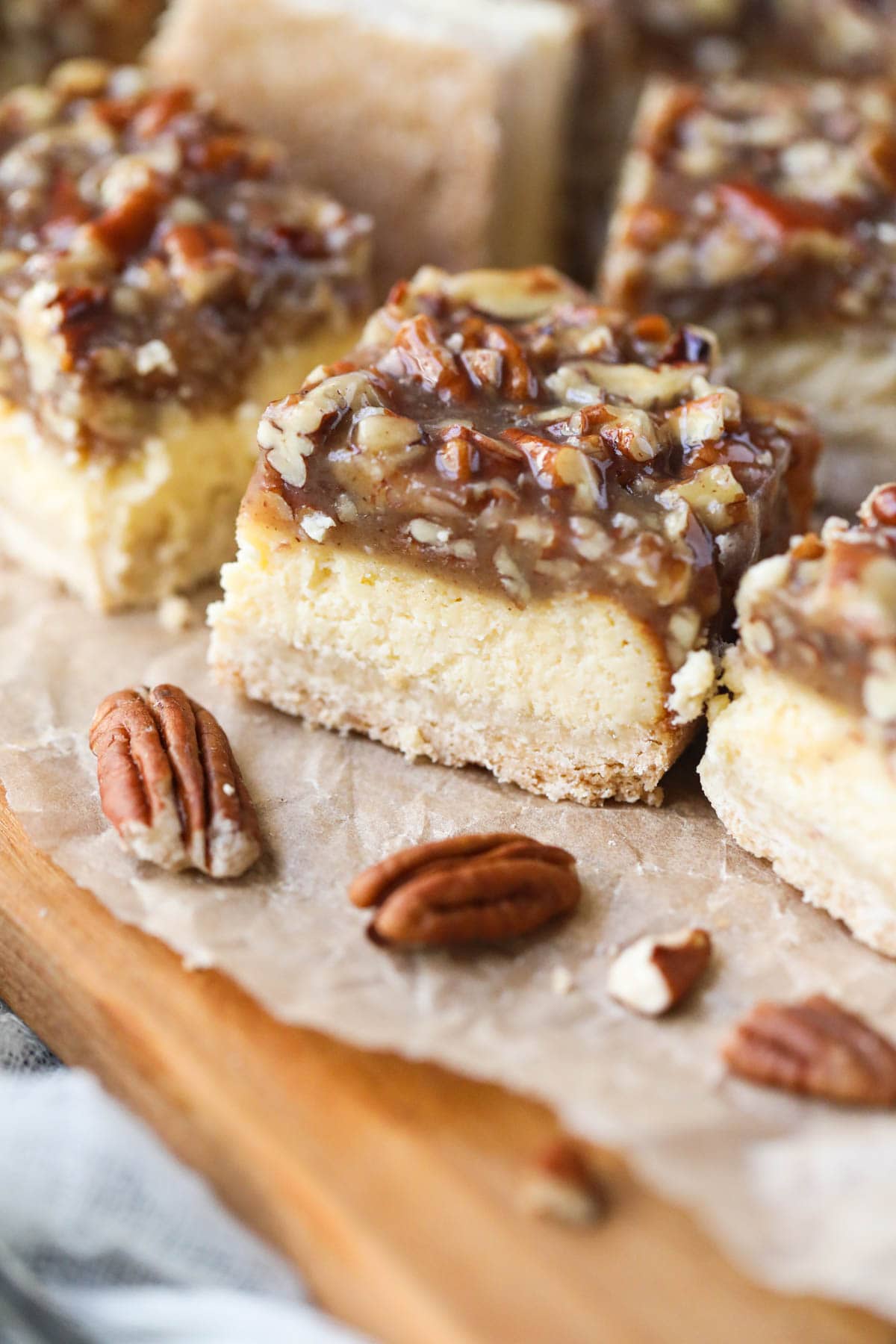 pecan pie cheesecake bars on parchment paper.